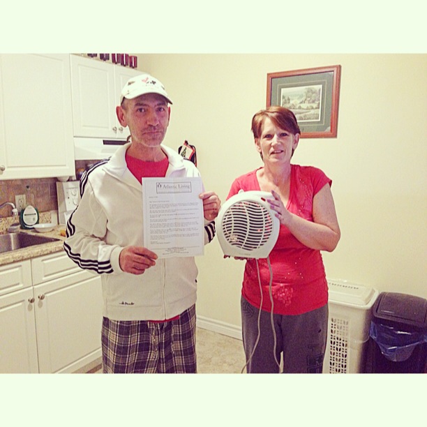 Paul Phillips and Georgina Cameron, tenants of a Dartmouth apartment building, display a written notice from their landlord and the heater they were given.